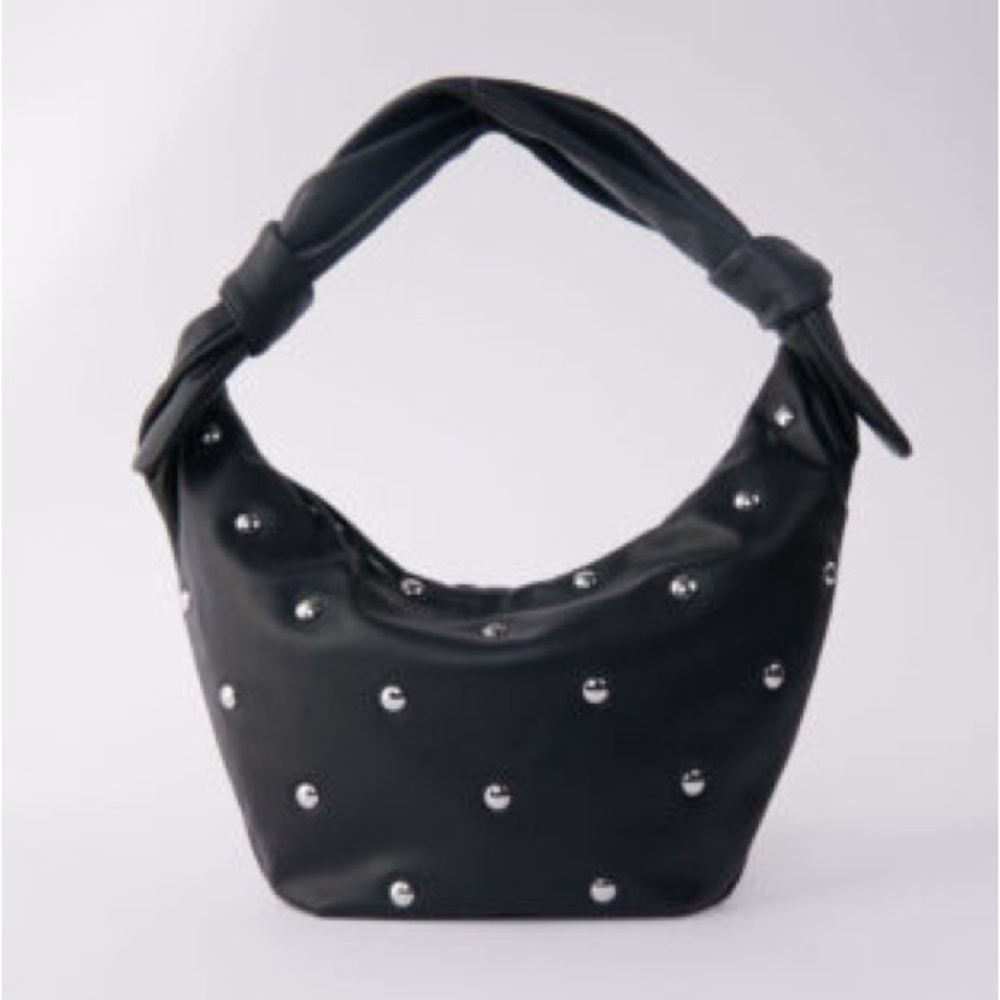 Maje “le bow bag” in black leather with silver studs